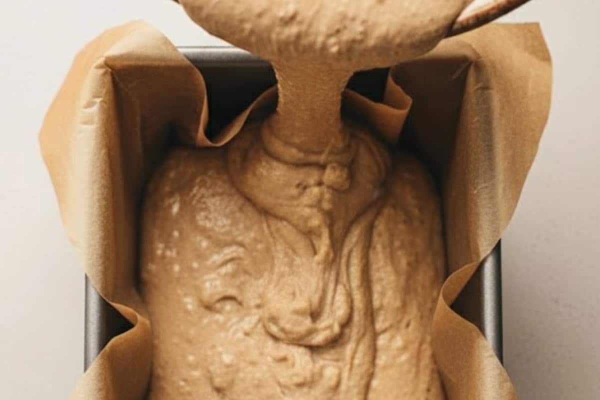Pour the batter into the prepared loaf pan.