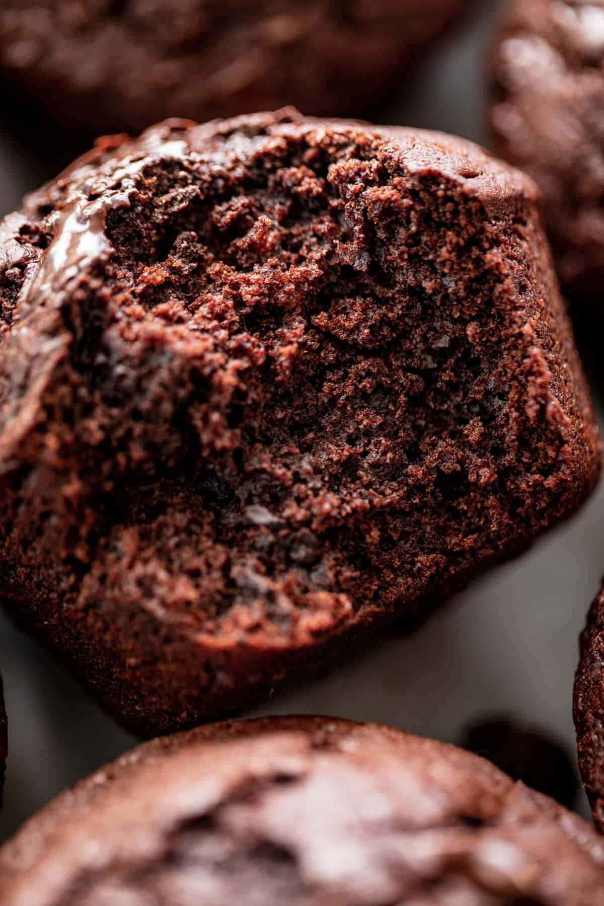 a bite taken out of a soft chocolate muffin