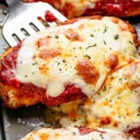 The Best Chicken Parmesan with a deliciously crispy breadcrumb coating, smothered in a rich homemade tomato sauce and melted mozzarella cheese! This is here best Chicken Parmesan you will ever make! Simple to make and worth every minute. If you love a crispy crumb coating vs soggy crumb, look no further!