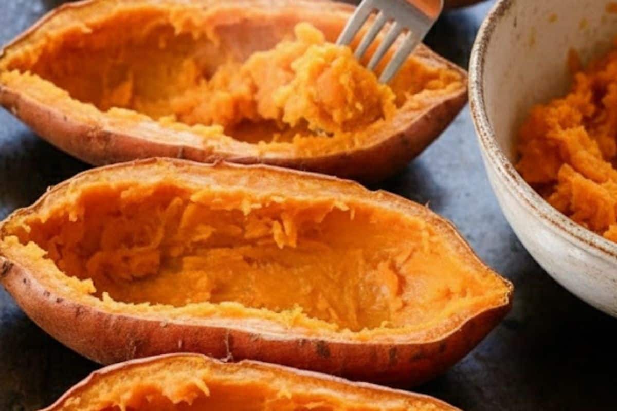 Slice the cooked sweet potatoes open lengthwise and gently scoop out most of the flesh, leaving about an inch around the edges so the skins can hold their shape, then set the scooped flesh aside for the filling.