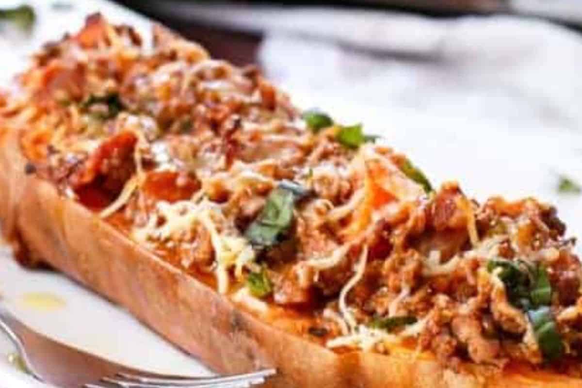 Spoon the mixture into the sweet potato shells, sprinkle with parmesan, then grill until the cheese melts and bubbles before finishing with fresh basil and serving.