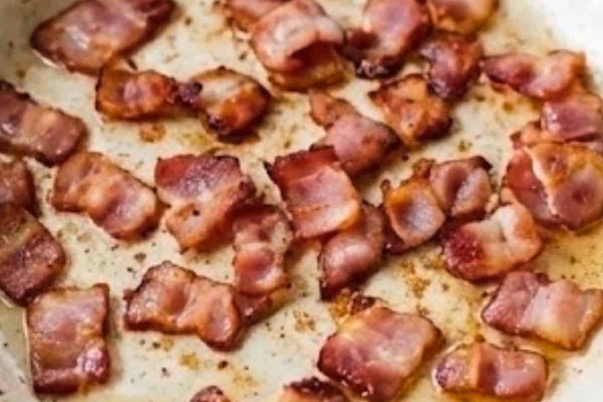 Fry three quarters of the bacon in a pan over medium heat until crisp.