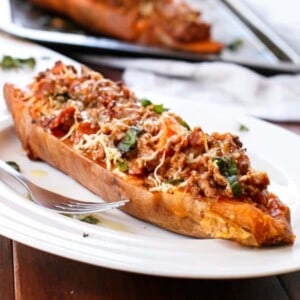 Cheesy Bacon Bolognese Stuffed Sweet Potatoes on a plate