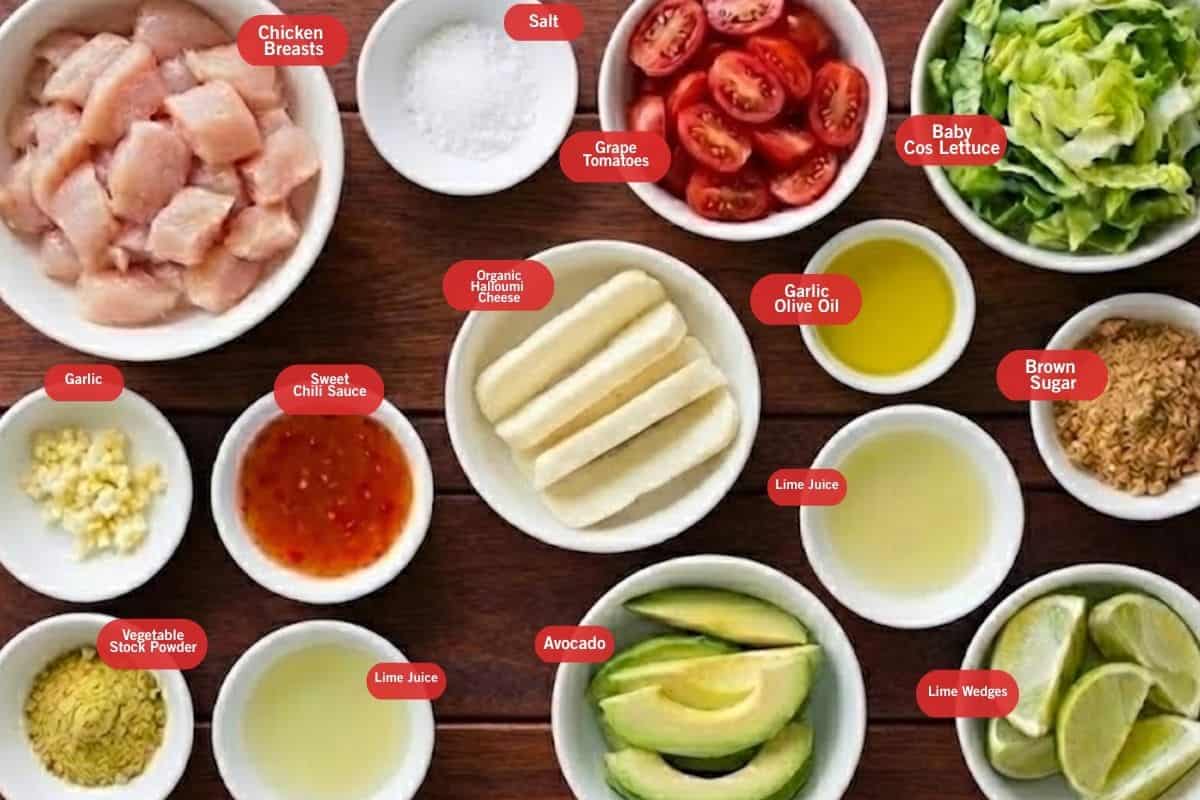 Flat lay photo of ingredient shot of chicken breasts, salt, grape tomatoes, baby cos lettuce, brown sugar, lime wedges, lime juice, garlic olive oil, avocado, sweet chili sauce, garlic, vegetable stock powder