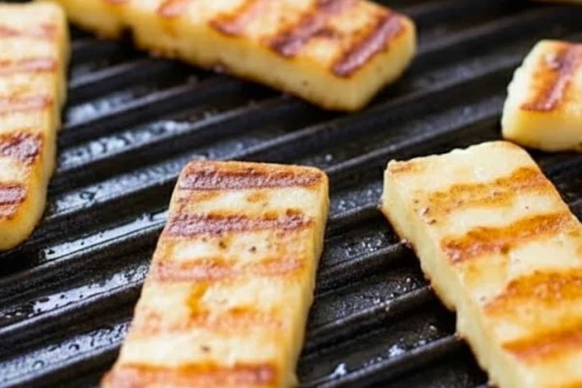 In a separate pan, fry the halloumi until golden on both sides and whisk all dressing ingredients together in a small bowl.