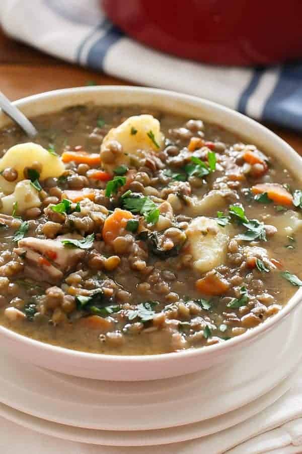 Top view of Warm Chicken and Pumpkin Lentil Stew with spoon in a bowl