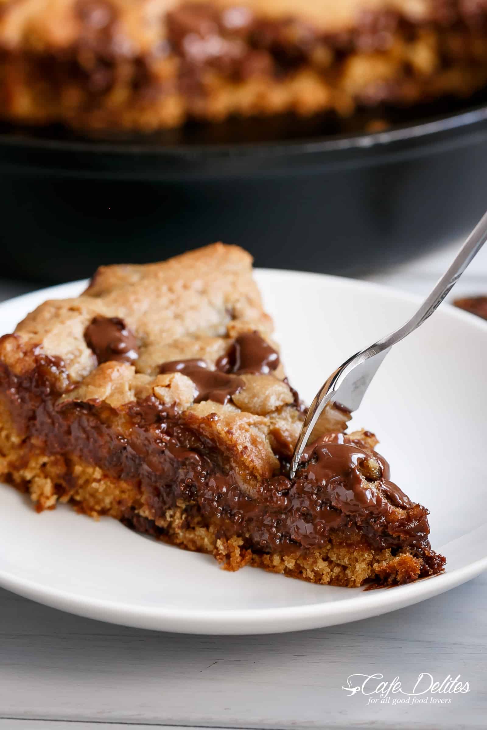 Nutella stuffed skillet cookie | cafedelites.com Nutella stuffed deep dish chocolate chip skillet cookie on a plate