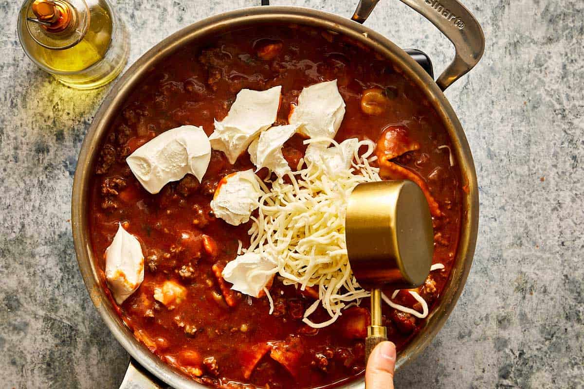 pouring mozzarella in mix for Beef Ravioli with Grilled Cheese Croutons