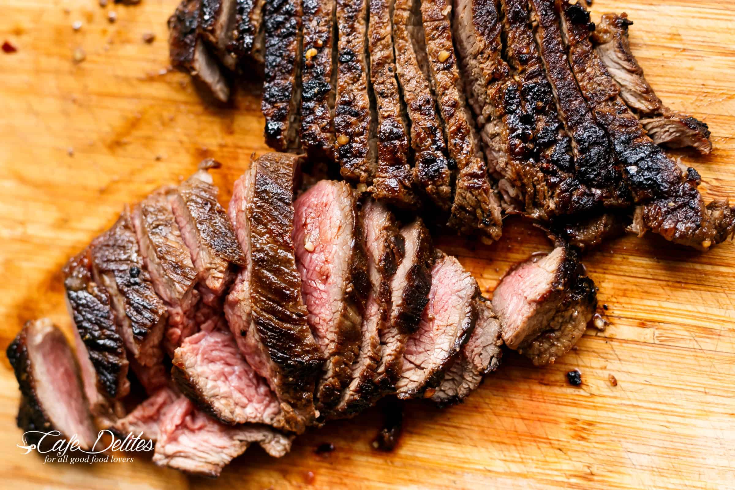 Grilled Steak slices on a wooden plank