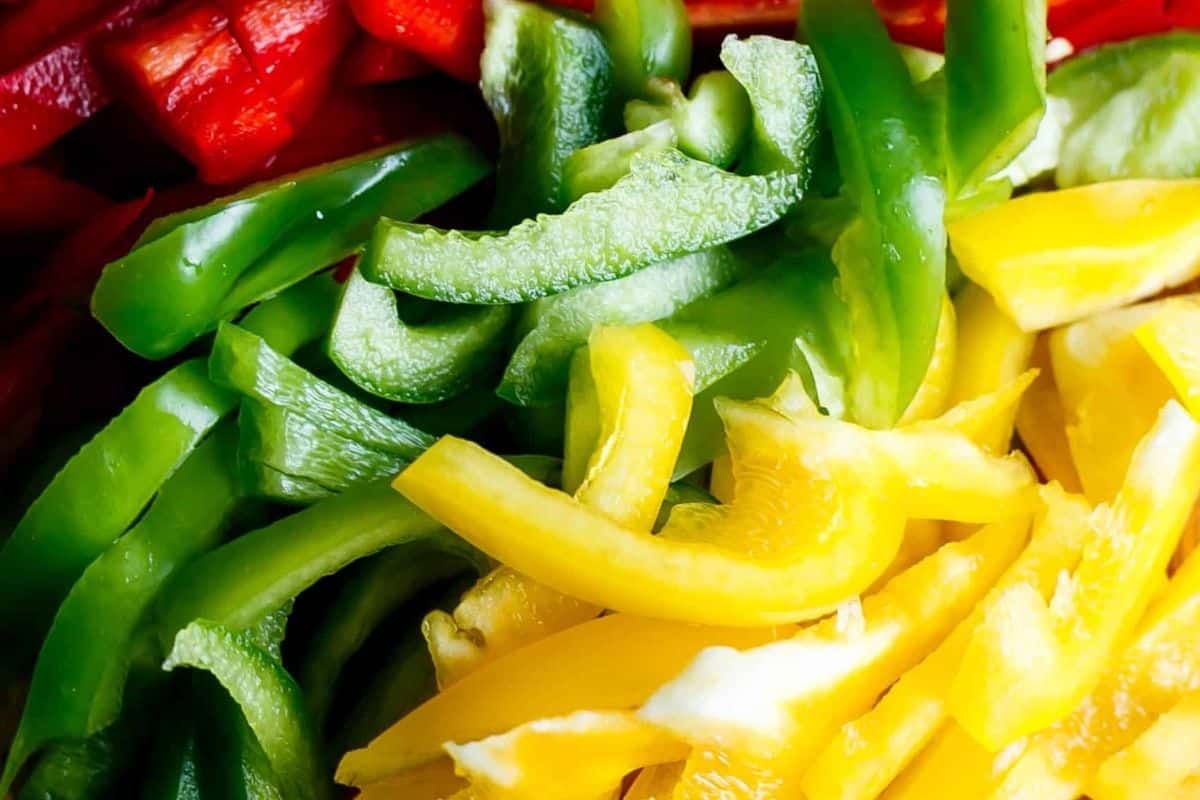Add the sliced peppers and onion to the remaining marinade