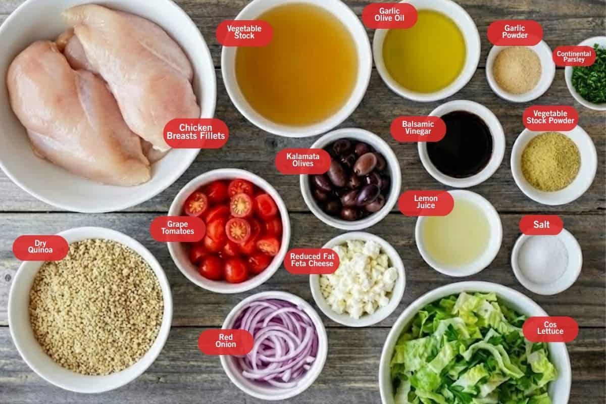 Flat lay photo of ingredient shot of chicken breasts fillets, vegetable stock, garlic olive oil, garlic powder, continental parsley, vegetable stock powder, salt, cos lettuce, lemon juice, balsamic vinegar, reduced fat feta cheese, red onion, grape tomatoes, dry quinoa, kalamata olives, salt, lemon juice