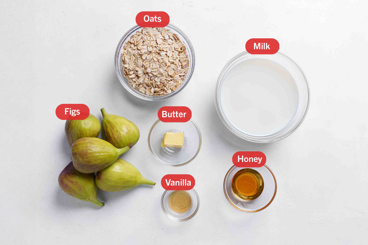 All the ingredients set out in bowls starting with a bowl of raw oats, a bowl of milk, five figs in a bunch, a cube of butter in a glass bowl, vanilla extract and a glass bowl of honey.