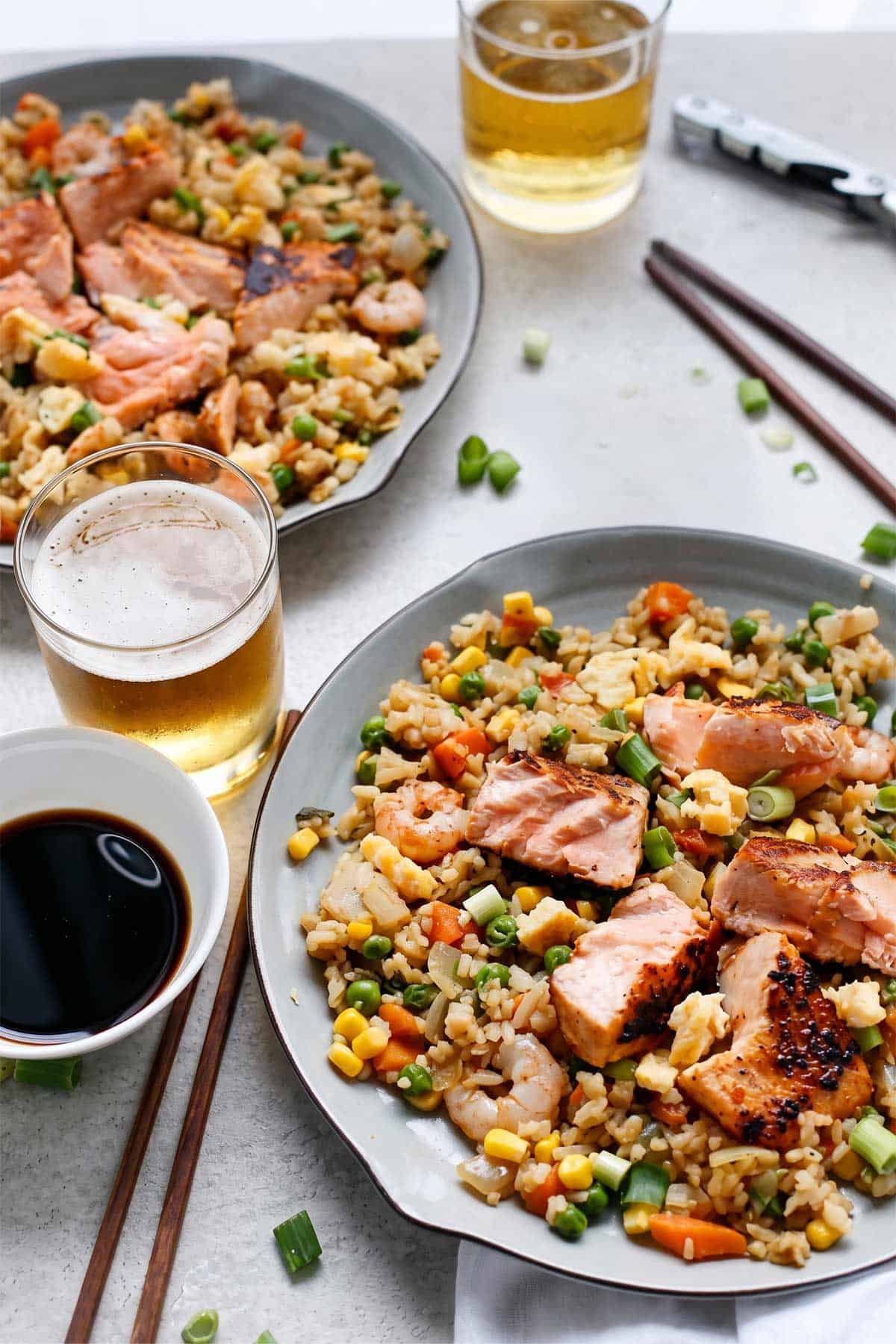Seared Salmon and Prawn Fried Rice with chop sticks on a plate