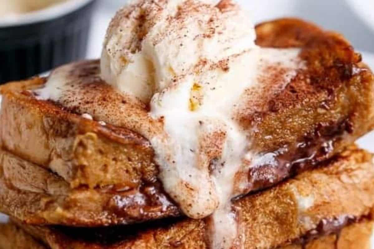 Top each Coffee French Toast with coffee cream, a scoop of ice cream if you’d like, and a sprinkle of chocolate dusting powder.