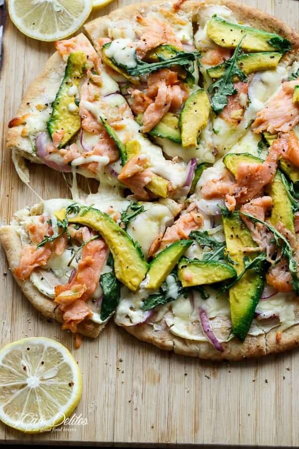 Smoked Salmon and Avocado Pizza being cut into pieces