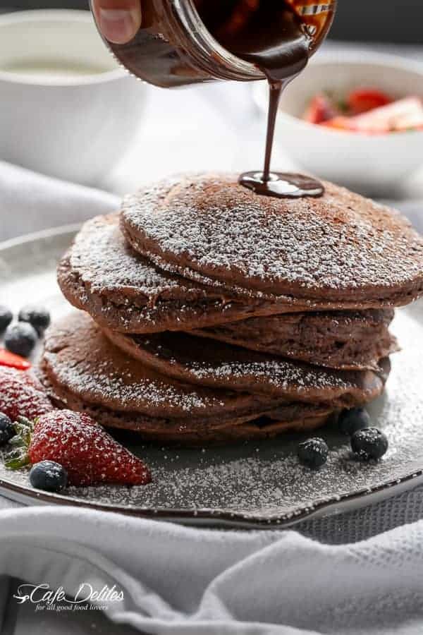 Chocolate sauce dripping over Double Chocolate Brownie Pancakes