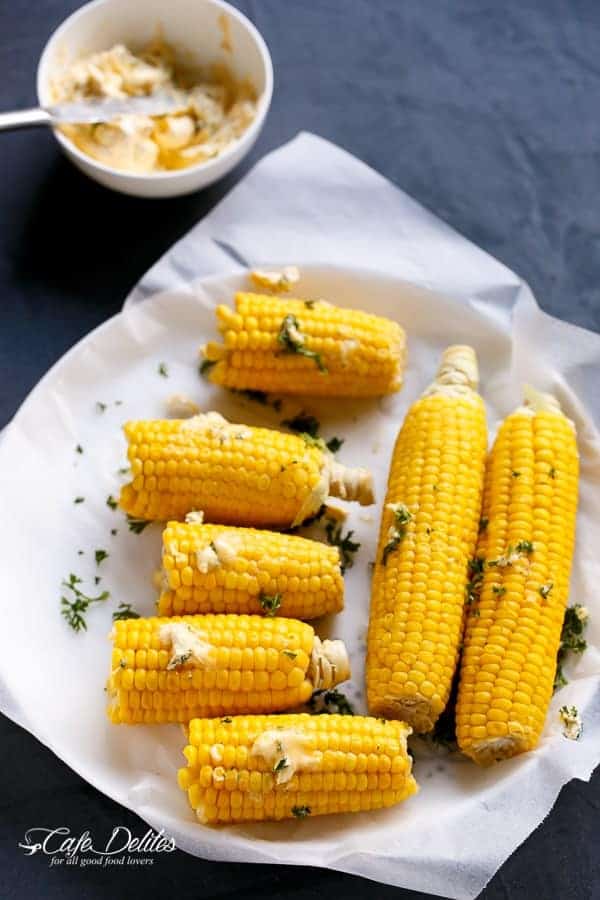 Raw corn toped with butter garlic before roasting