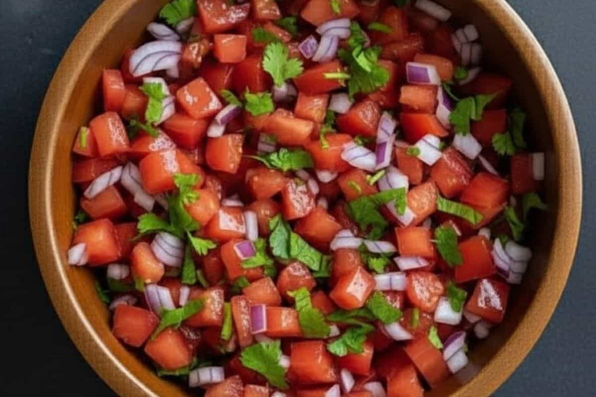 Combine tomatoes, onions, and cilantro in a bowl, drizzle with lime juice, and season with salt