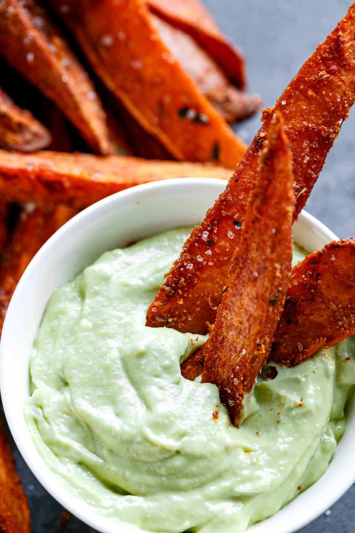 Crispy Sweet Potato Wedges with Garlic Avocado Aioli in a bowl