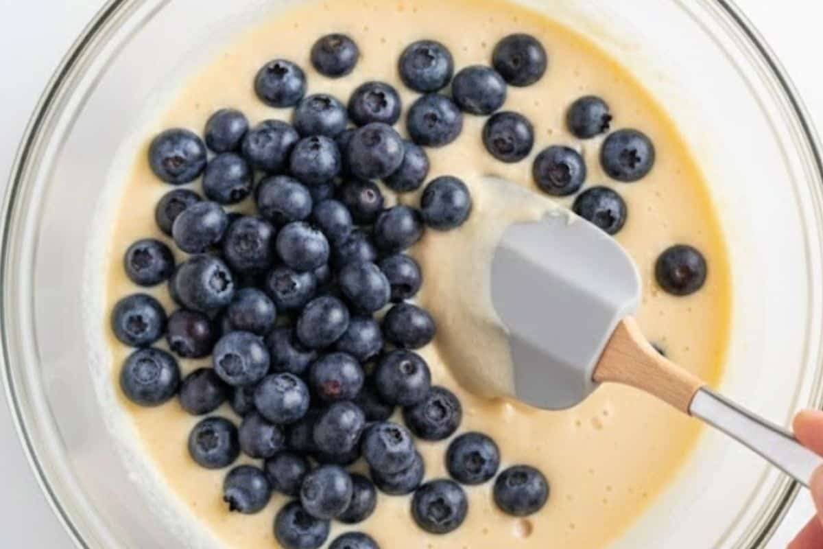 Gently fold the blueberries through the batter,