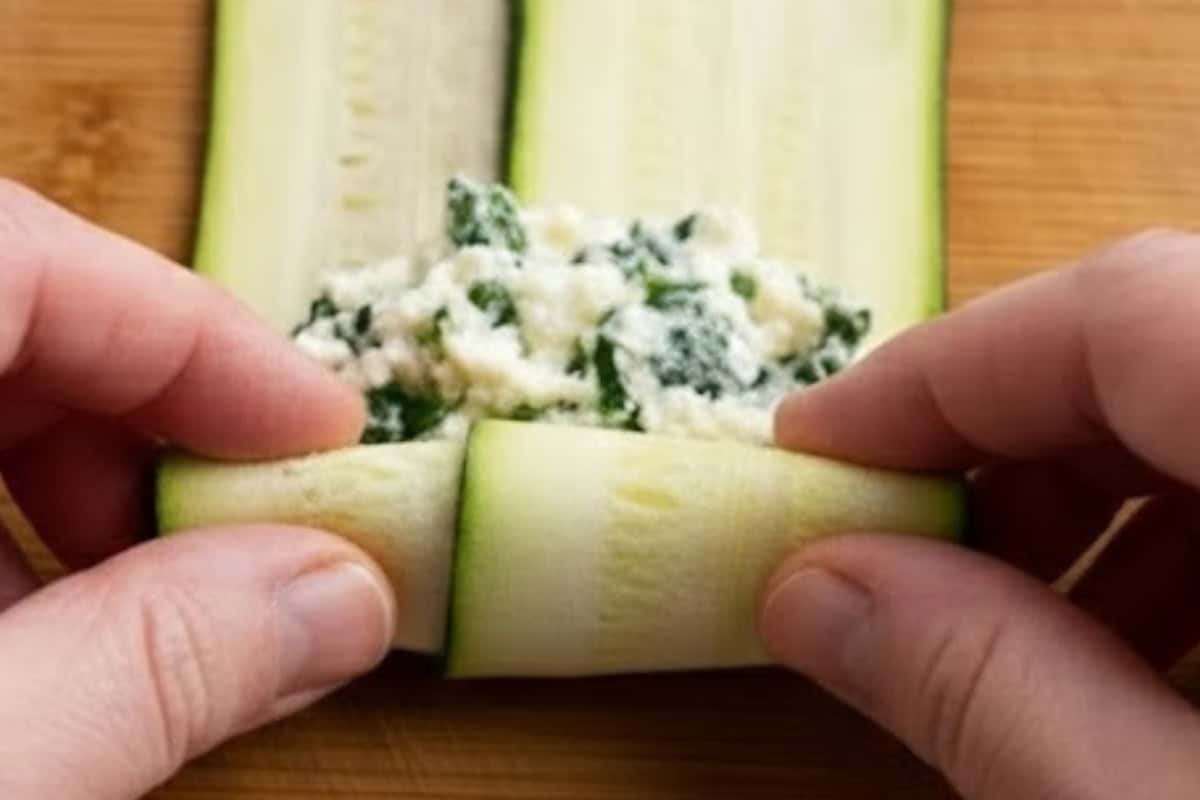 Lay two zucchini ribbons overlapping, spoon 1 to 2 tablespoons of the mixture