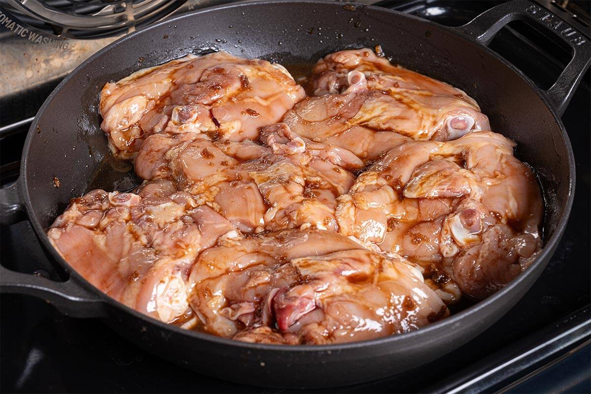 chicken in a skillet being heated in oven