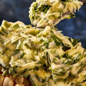 a thick layer of butter on a corn cob
