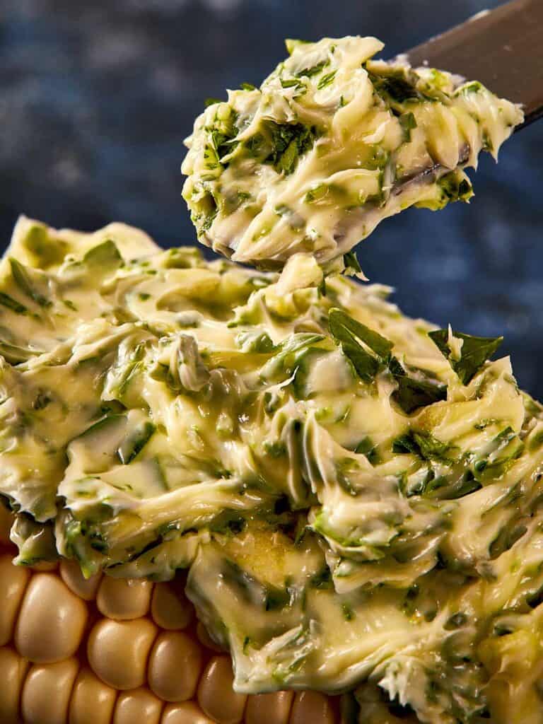 a thick layer of butter on a corn cob