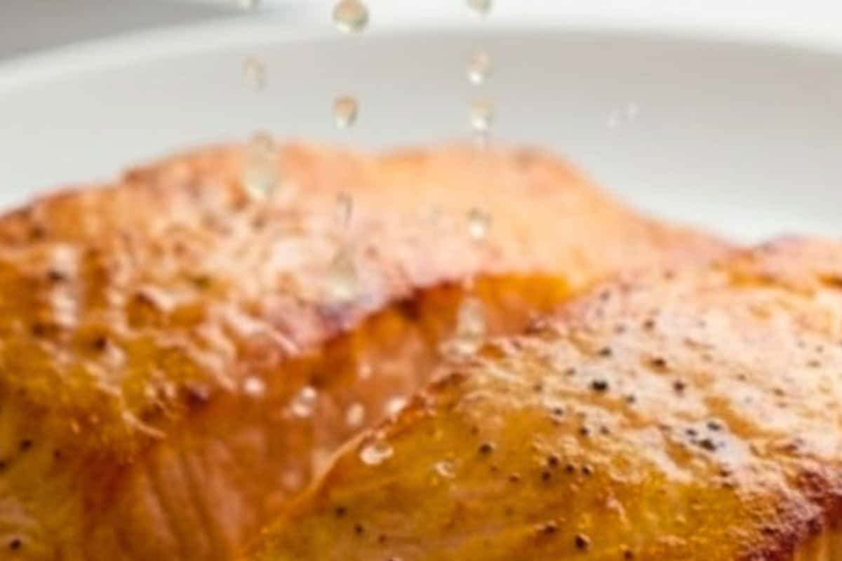 Transfer the salmon to a warm plate and squeeze lemon juice over each fillet.