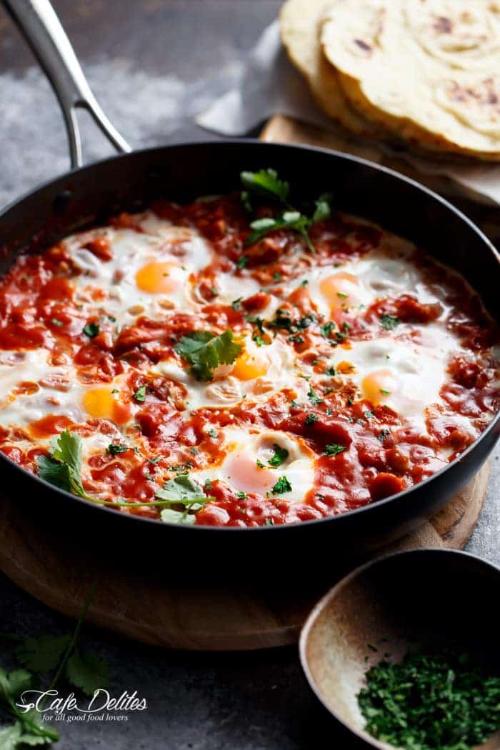 Eggs In Tomato Sauce with Sausage (Shakshuka) cooking in a pan