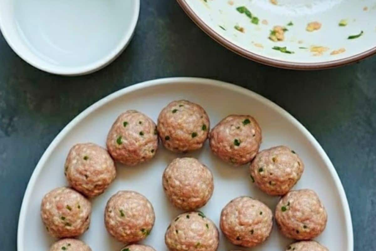 Fill a bowl with water, dip your hands in and shake off excess, then roll 1 tablespoon of mixture into a ball