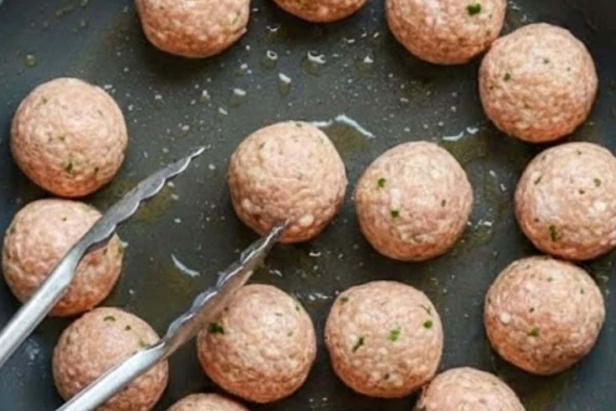 Heat a small amount of oil in a large nonstick pan over medium heat, then cook meatballs in batches
