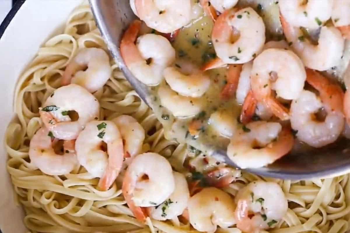 Adding the shrimp into the pasta.