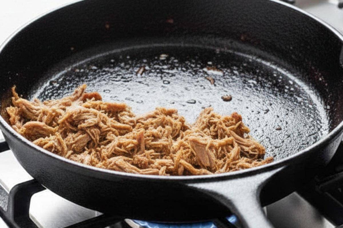 Warming the meat in a skillet.