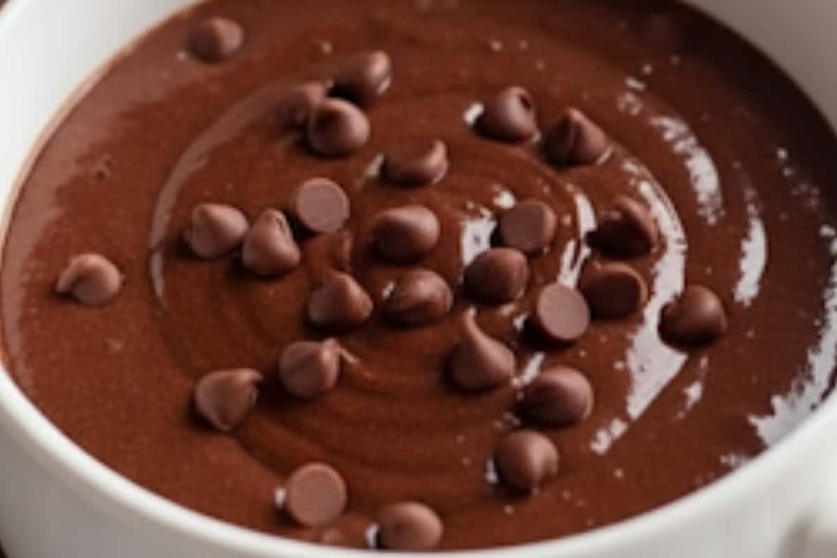 Stir in melted butter, milk, and vanilla until the batter is smooth and glossy. Fold in 1/2 tablespoon mini chocolate chips.