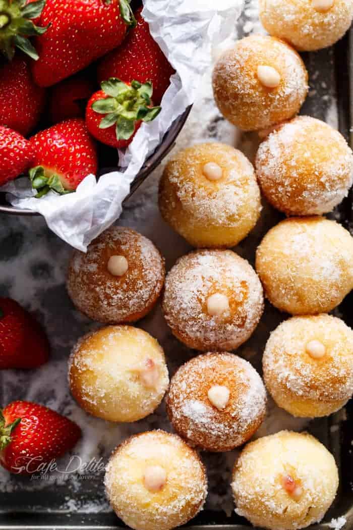 Strawberry Cheesecake Donut Holes with some fresh strawberries