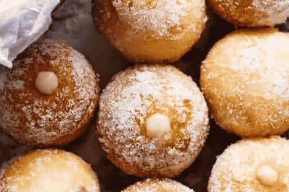 Transfer the filling to a piping bag fitted with a narrow nozzle and pipe into each donut hole until just puffed and filled