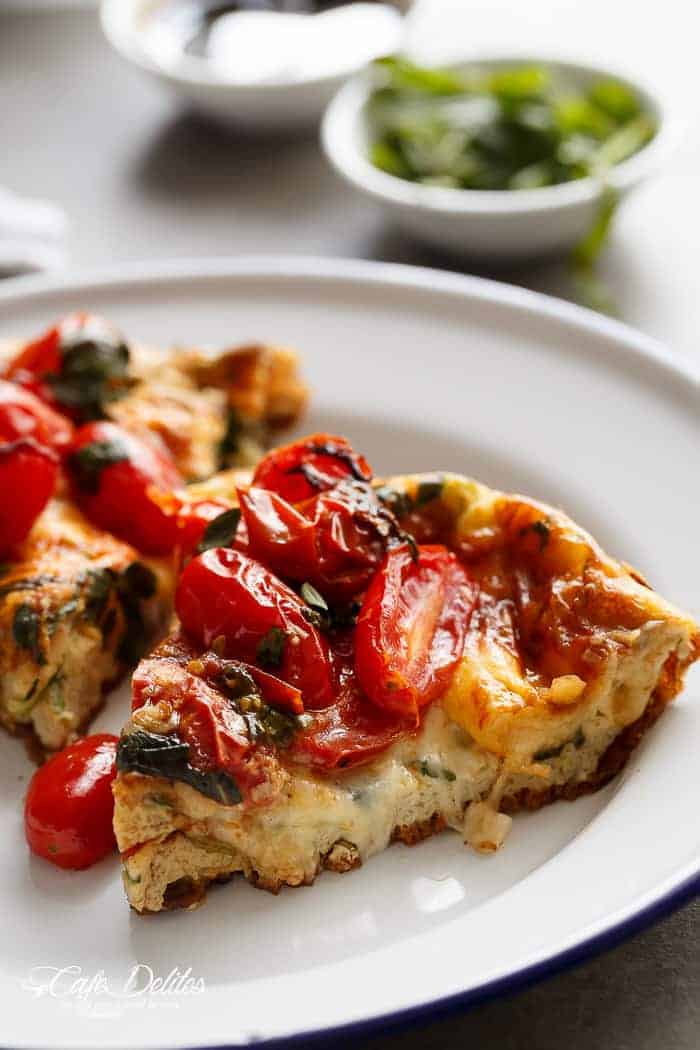 Garlic infused, Caprese Frittata with pan fried, juicy tomato and fresh basil flavors on a plate