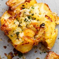 Crispy Garlic Butter Parmesan Smashed Potatoes with crispy edges that will send you over the edge!