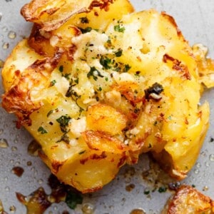 Crispy Garlic Butter Parmesan Smashed Potatoes with crispy edges that will send you over the edge!