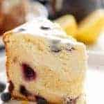 A piece of Blueberry Lemon Cheesecake Cake