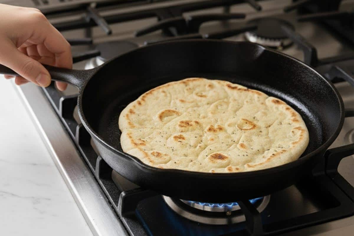 Warming the flatbread in a pan.