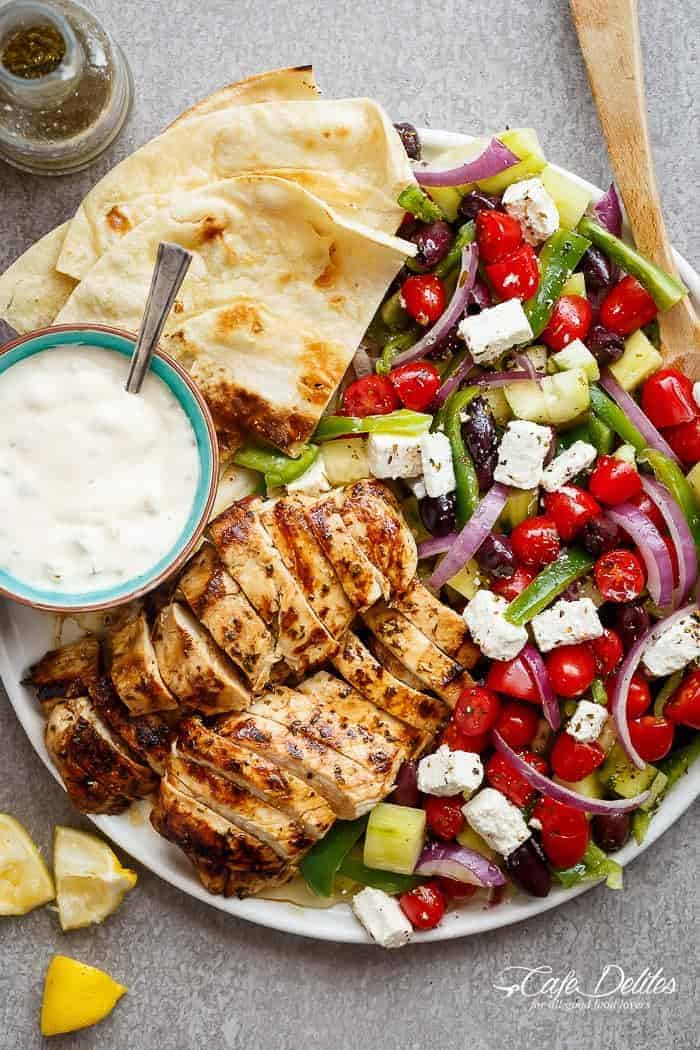 Greek Lemon Garlic Chicken Salad with an incredible dressing that doubles as a marinade! Complete with Tzatziki and homemade flatbreads, it\'s a winner!