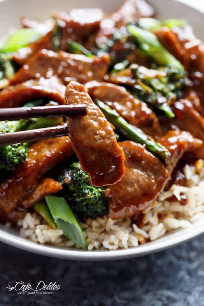 Image focusing on a beef piece from Mongolian Beef And Broccoli with rice in bowl