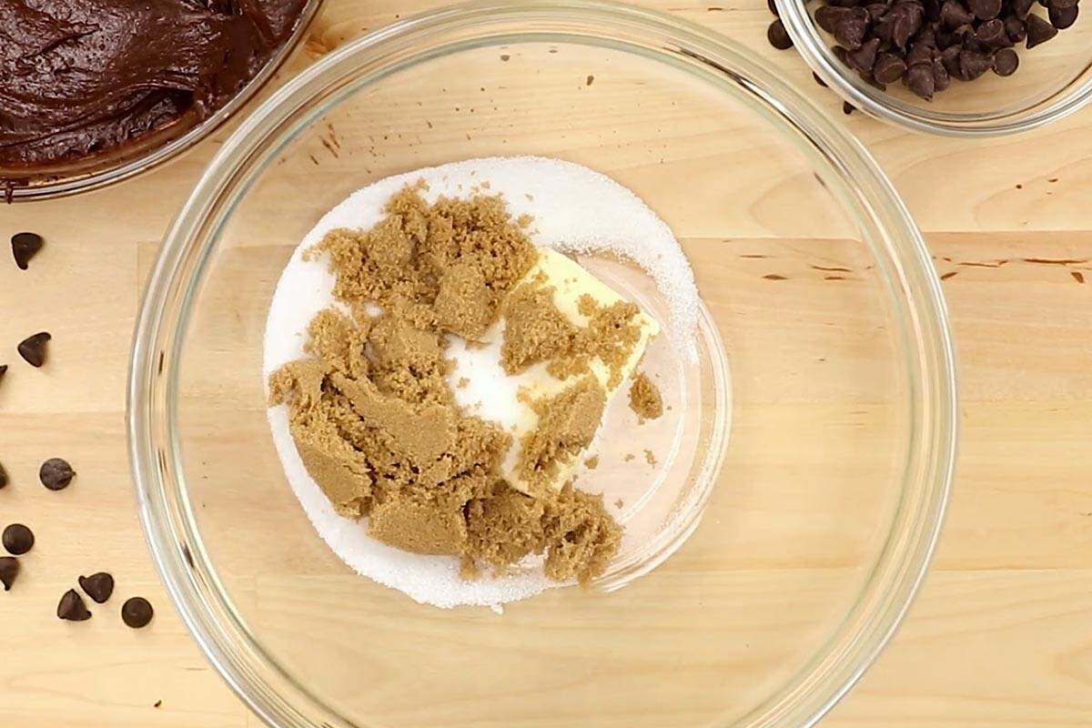 Softened butter with brown sugar and granulated sugar in a bowl.