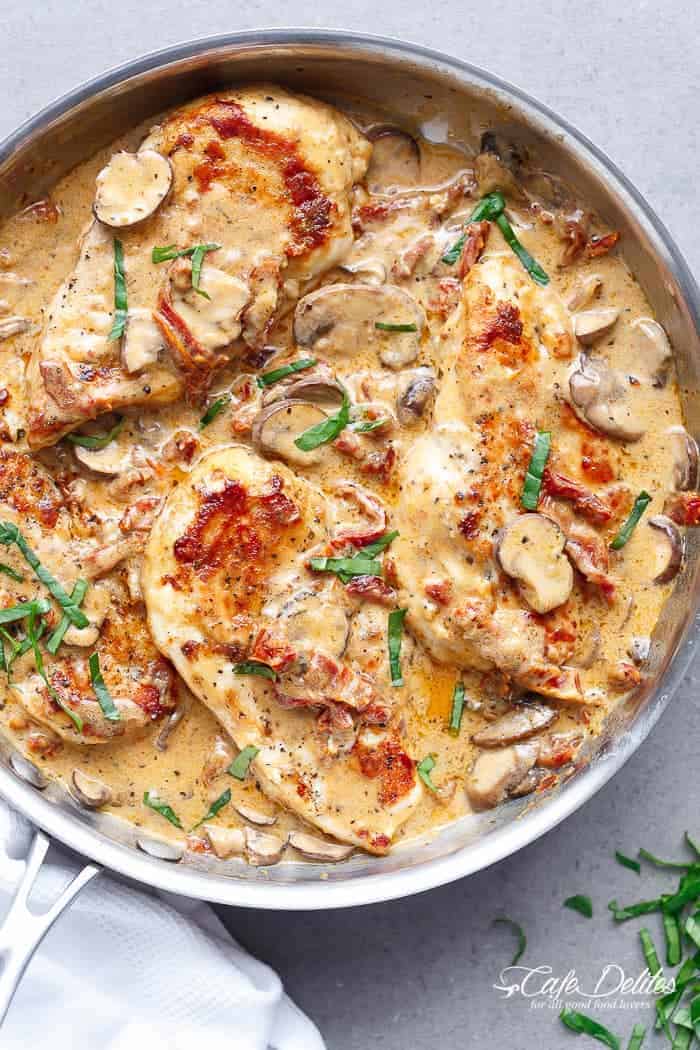 Top view image of Creamy Sun Dried Tomato Parmesan Chicken on a baking tray