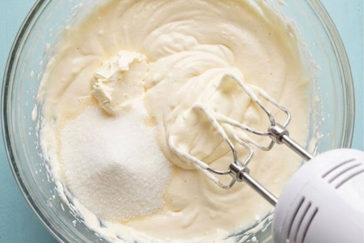 In a large bowl, beat the cream cheese, cream, and sugar with an electric mixer.