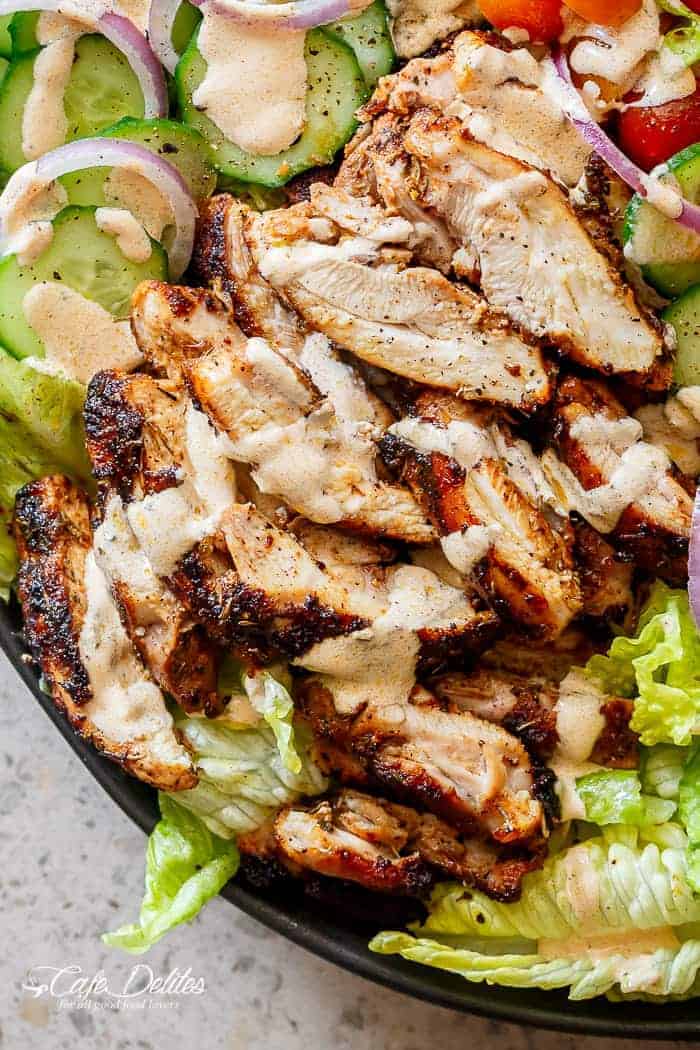Image focusing on chicken pieces from Grilled Cajun Chicken Salad with Creamy Cajun Dressing on a platter