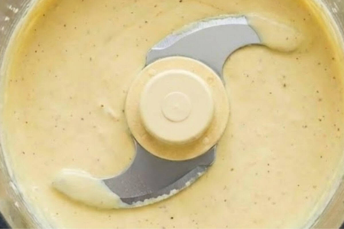 Add yogurt, mayo, olive oil, garlic, anchovy, lemon juice, and Parmesan to a food processor
