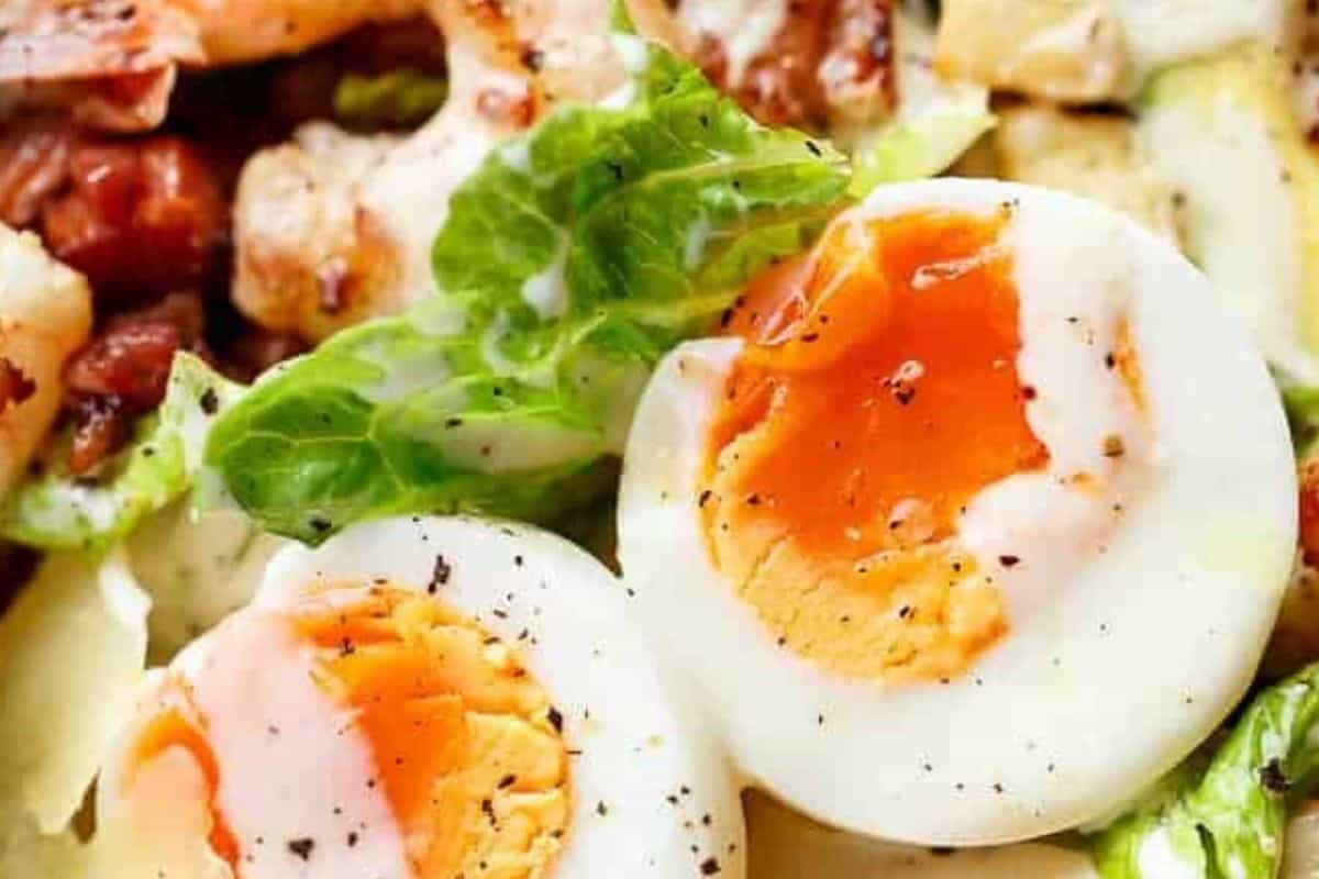 Slice the soft boiled or poached egg and arrange it over the top of the salad and serve immediately
